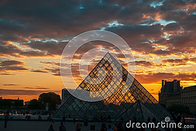 Beautiful sunset clouds over the Paris Louvre Museum with the pyramid silhouette Editorial Stock Photo