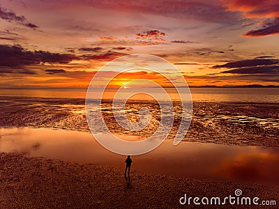 Beautiful sunset colors over the coastline of Allerdale district in Cumbria, UK. Sun setting over the shore of Allonby bay on Stock Photo