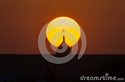 Beautiful sunset in the evening behind the silhouette muslim mosque Stock Photo