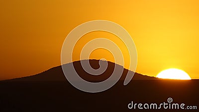 A beautiful sunset with a hill Stock Photo