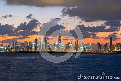 Beautiful sunset over the iconic buildings of Dubai. Amazing gray clouds and orange color sky. The modern and luxury cityscape pan Editorial Stock Photo