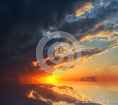 Beautiful sunset over the ocean with dramatic autumn sky Stock Photo