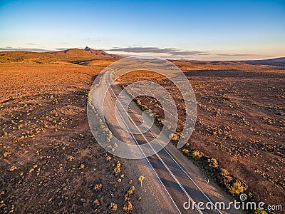 Sunset over rural highway passing through South Australian desert. Stock Photo