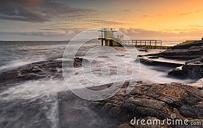 Beautiful sunset scenery of Blacrock diving tower on Salthill beach in Galway city, Ireland Stock Photo