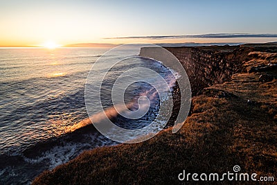 Beautiful sunset at scenic Krisuvikurberg cliffs on a warm bright day in autumn at the rough atlantic coast in iceland Stock Photo