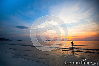 Beautiful sunset on the sea beach, swimming girls silhouette Stock Photo