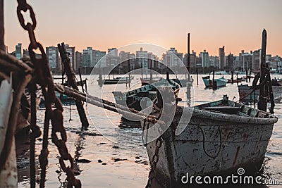 Beautiful sunset showing several fishing boats on a small and famous beach on Ilha do Frade, in VitÃ³ria, Brazil. Stock Photo