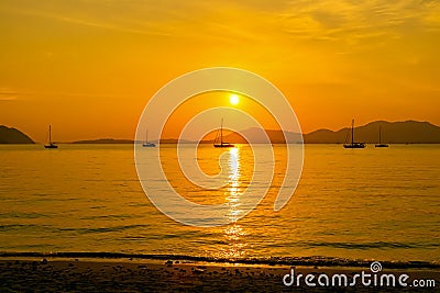 Beautiful sunset and silhouette sailing boats. Stock Photo