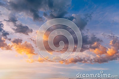 Beautiful sunset sky above clouds with dramatic light. Sunset sky for background, sunrise sky and clouds. Bright orange and blue Stock Photo