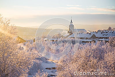 Beautiful sunset at the small Norwegian town Roros. Church in the evening sun. Stock Photo