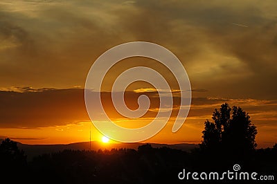 An amazing sunset under a cloudy sky Stock Photo