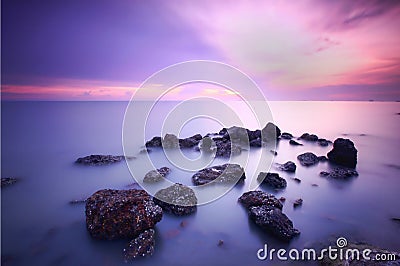 Beautiful sunset view and black stones Stock Photo