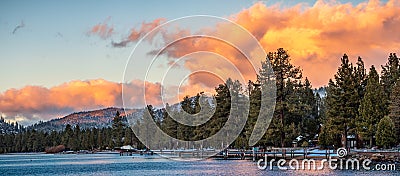 Beautiful sunset views of the shoreline of South Lake Tahoe, houses visible among pine trees Stock Photo