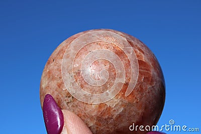 Sunstone Sphere on Blue background Stock Photo