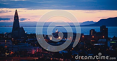 Beautiful super wide-angle aerial view of Reykjavik, Iceland with harbor and skyline mountains and scenery beyond the city, seen f Stock Photo