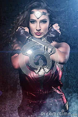 Beautiful superhero woman showing strength Editorial Stock Photo