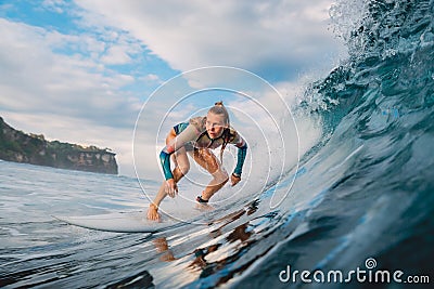 Beautiful surfer girl on surfboard. Woman in ocean during surfing. Surfer and barrel wave Stock Photo