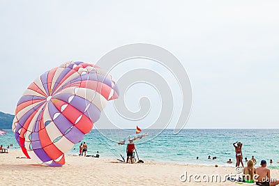 Beautiful Surin beach in Choeng Thale city, Phuket, Thailand with colorful parachute white sand, turquoise water and palm trees Editorial Stock Photo