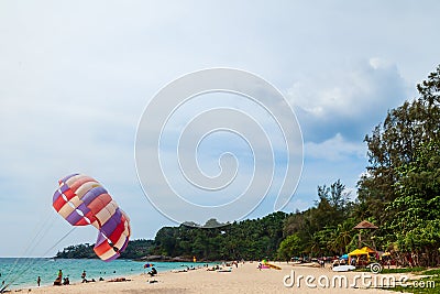 Beautiful Surin beach in Choeng Thale city, Phuket, Thailand with colorful parachute white sand, turquoise water and palm trees Editorial Stock Photo