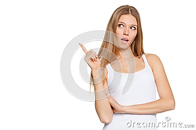 Beautiful surprised woman in excitement pointing to the side. Isolated over white Stock Photo