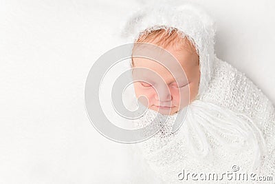 Beautiful swaddled baby in white closeup Stock Photo