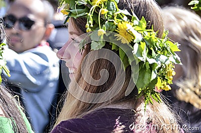 Beautiful swedish people and woman are enjoying mid summer day wearing crown made of leaves in sunny day Editorial Stock Photo
