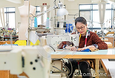 Beautiful sweet clothing factory sewing woman Stock Photo