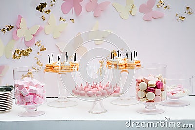 A beautiful sweet dessert with an airy white kem. Portion cakes. Pink white crimson macaroons. Pink marshmallow. Candy bar Stock Photo