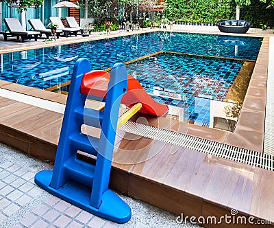 Beautiful swimming pool with tot slide. Stock Photo