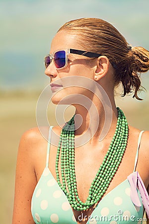Beautiful tanned blond woman on the beach sunbathing Stock Photo