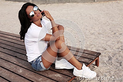 Beautiful tanned girl with dark hair in casual clothes Stock Photo