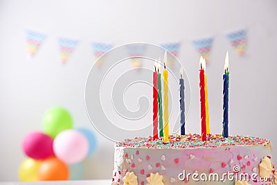 Beautiful tasty birthday cake with candles on blurred background Stock Photo