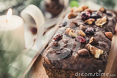 Beautiful tasty dried mixed nut Christmas fruit cake on wooden table Stock Photo