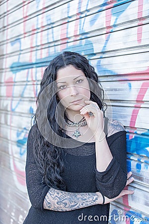 Beautiful tattooed woman urban style. Stock Photo