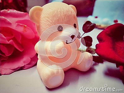 Beautiful Teddy bear in Pink colour with red roses. Stock Photo