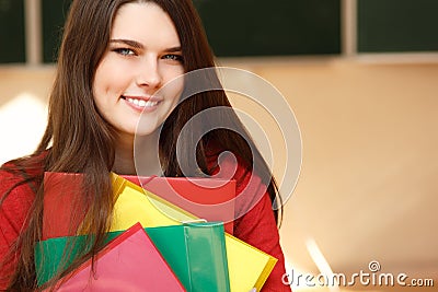 Beautiful teen girl in classroom happy smiling Stock Photo