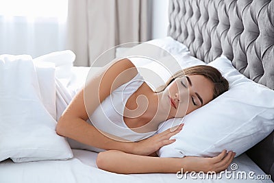 Beautiful teen girl sleeping with comfortable pillow in bed Stock Photo