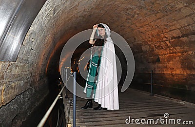 A teenage girl in the Templars tunnel in Akko, Israel Stock Photo