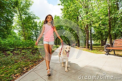 Beautiful teenage girl walking her dogs Stock Photo