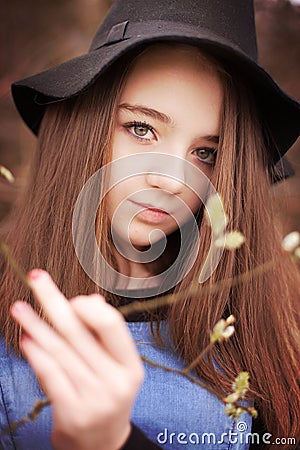 Beautiful teenage holding a branch in blossom Stock Photo