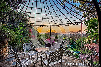 Beautiful terrace with the view of a fancy garden at sunset Stock Photo