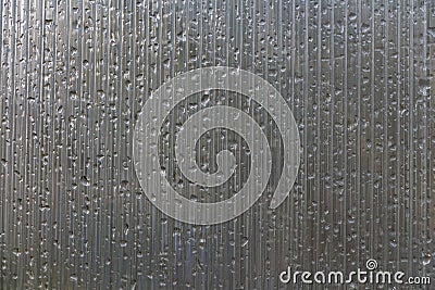 A beautiful texture of the wet misted Polycarbonate Sheet with raindrops Stock Photo