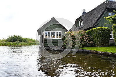 Beautiful thatched buildings in the famous village of Giethoorn in the Netherlands with water canals. Editorial Stock Photo