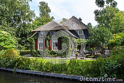 Beautiful thatched buildings in the famous village of Giethoorn in the Netherlands with water canals. Editorial Stock Photo