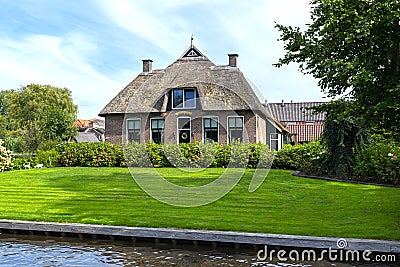 Beautiful thatched buildings in the famous village of Giethoorn in the Netherlands with water canals. Editorial Stock Photo