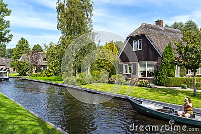 Beautiful thatched buildings in the famous village of Giethoorn in the Netherlands with water canals. Editorial Stock Photo