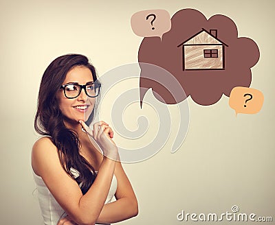 Beautiful thinking business woman in glasses looking on illustration house in bubble above with questions. Insurance protection c Cartoon Illustration