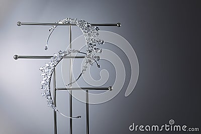 Beautiful tiaras with diamonds on stand against grey background. Space for text Stock Photo