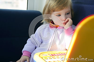 Beautiful toddler little girl with toy computer Stock Photo