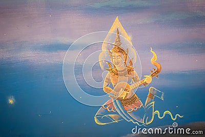 Beautiful traditional Thai style angels painting of folk literature on the ceiling at public Buddhist temple in Thailand. Stock Photo